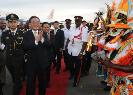 Wu Bangguo (2nd L, Front), chairman of the Standing Committee of China's National People's Congress, is welcomed upon his arrival at the airport in Nassau, the Bahamas, on Sept. 3, 2009. Wu Bangguo arrived here on Thursday afternoon, kicking off his official visit to the Bahamas on the second leg of his three-nation America tour. (Xinhua/Ma Zhancheng) 