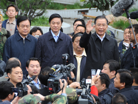 Chinese Premier Wen Jiabao speaks to rescue workers at the Beichuan middle school in Beichuan County, which neighbors the epicenter of the Monday's 7.8 magnitude earthquake, southwest China's Sichuan Province, May 14, 2008. Wen arrived at Beichuan to oversee the rescue work in Sichuan Province. 