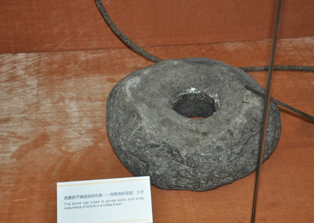 A stone cap that was used to gouge eyes of serfs in a Lhasa prison in old Tibet is on display at an exhibition marking the 50th anniversary of the Democratic Reform in Tibet Autonomous Region in Beijing, Feb. 25, 2009. 