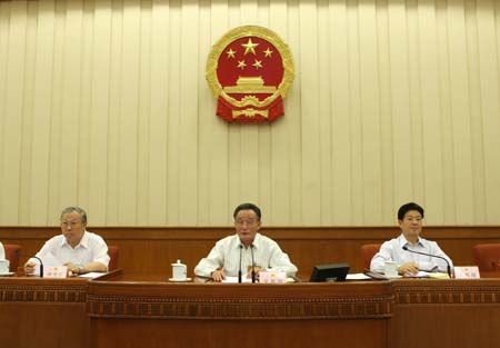 Wu Bangguo (C), chairman of the Standing Committee of China's National People's Congress (NPC), addresses the closing session of the ninth session of the Standing Committee of the 11th National People's Congress, in Beijing, capital of China, on June 27, 2009. (Xinhua/Liu Weibing) 