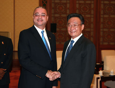 Wu Bangguo (R), chairman of the Standing Committee of the National People's Congress (NPC), China's top legislature, shakes hands with David Thompson, Prime Minister of Barbados in Beijing, capital of China, May 5, 2008.